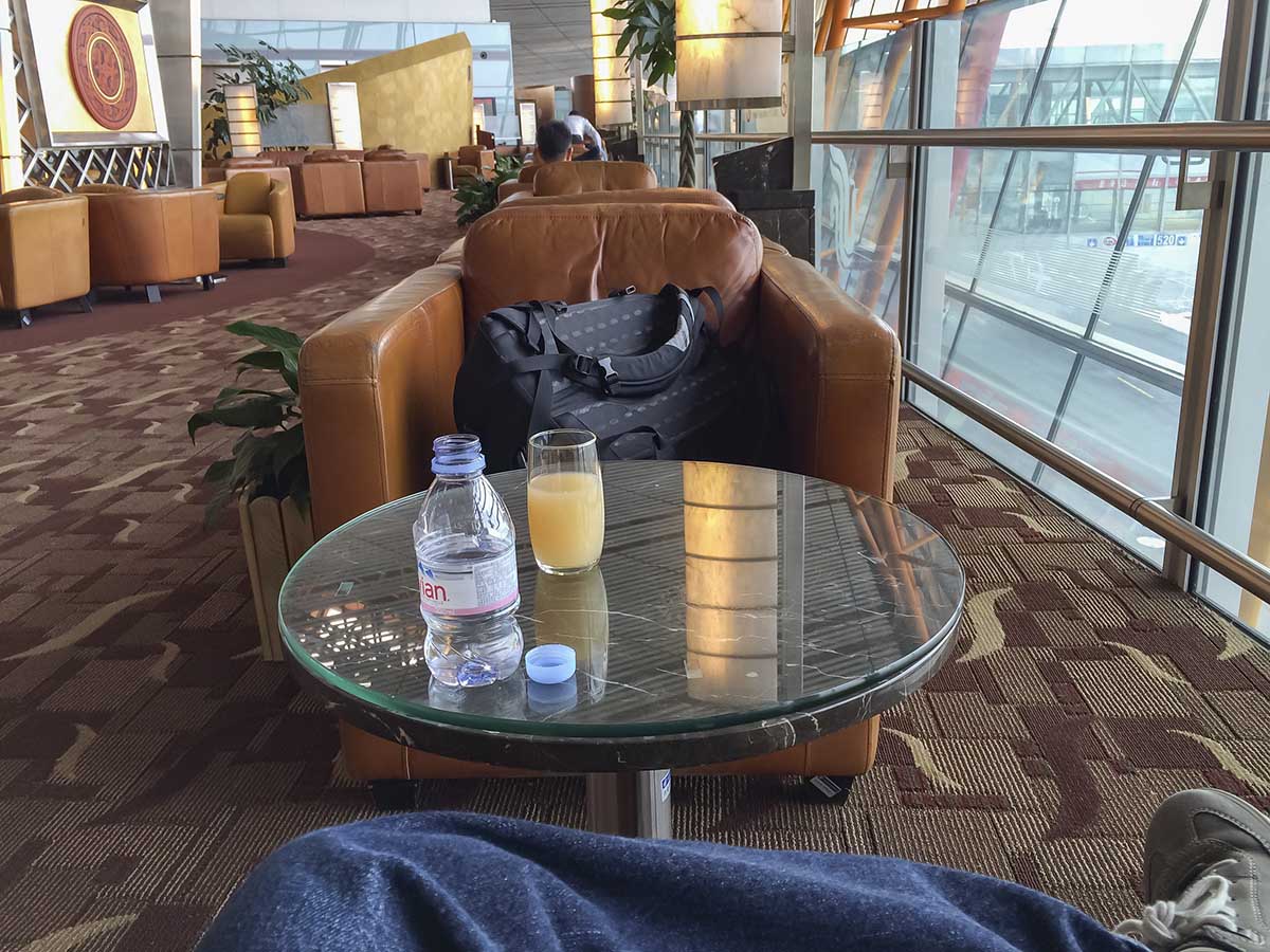 Having drinks inside the Air China first class lounge Beijing airport