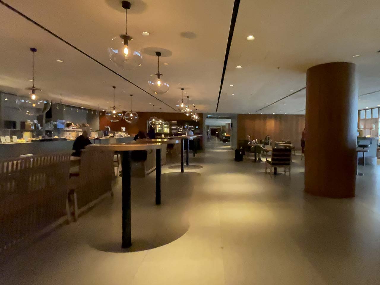 Layout of the Cathay Pacific The Pier Lounge Hong Kong showing the food bar against the back wall and lounge seating along the windows
