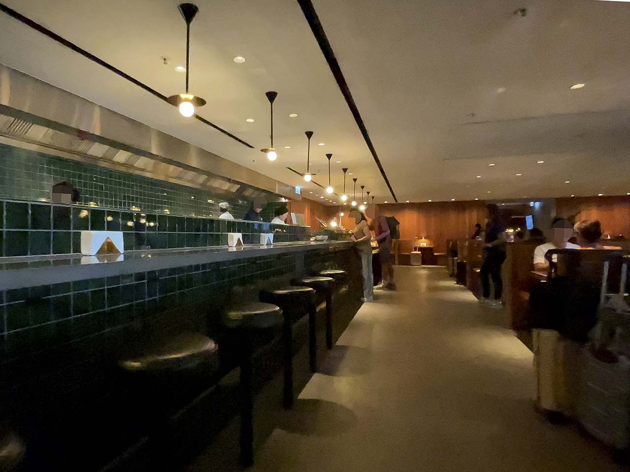 Hot food bar with chefs serving made to order Asian dishes in the Cathay Pacific The Pier Lounge Hong Kong