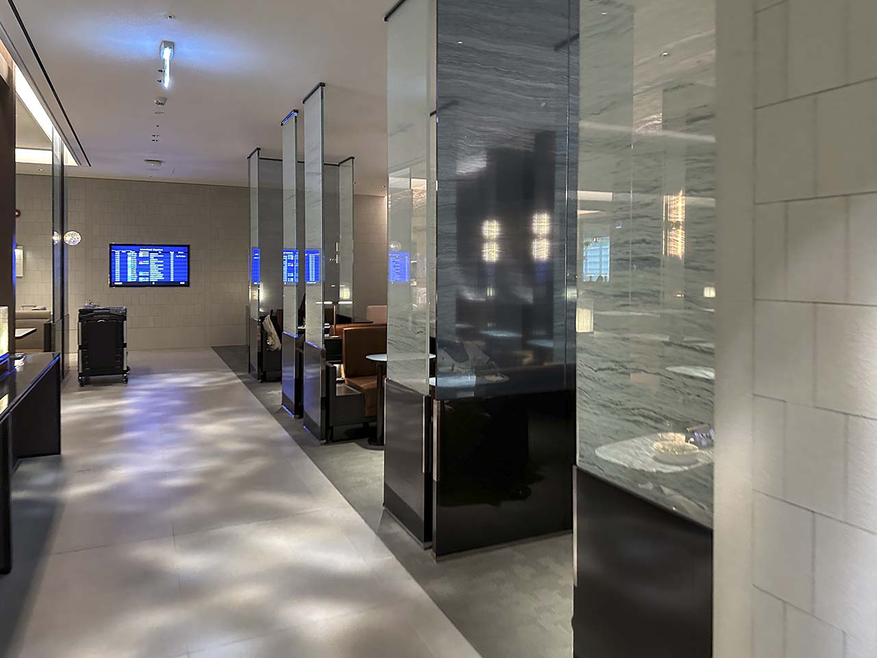 Private seating areas with translucent glass partitions inside the Korean Air Lounge Incheon