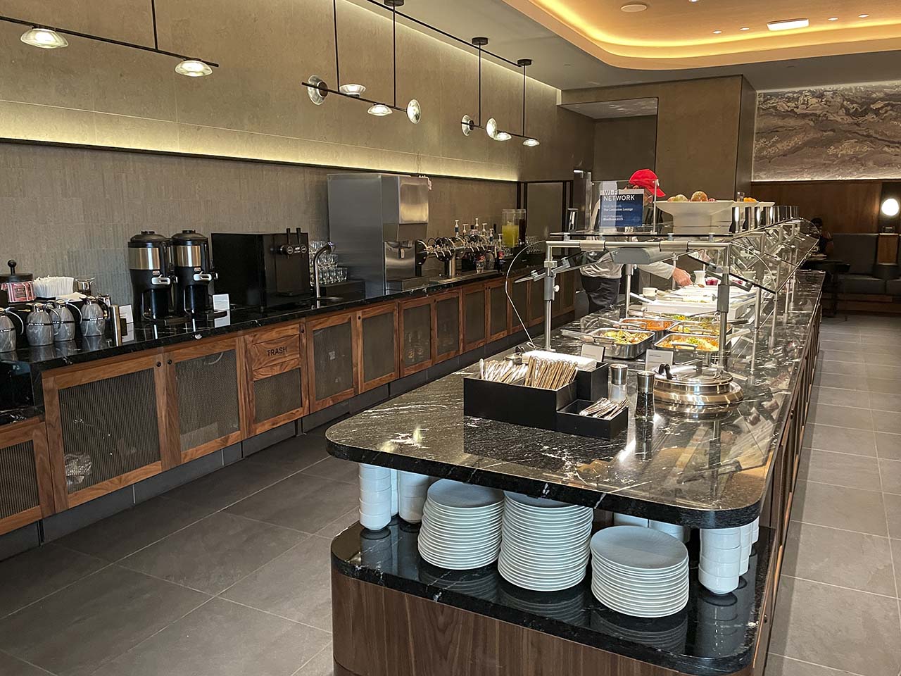 Main food bar serving hot and cold items in the SLC Amex Lounge
