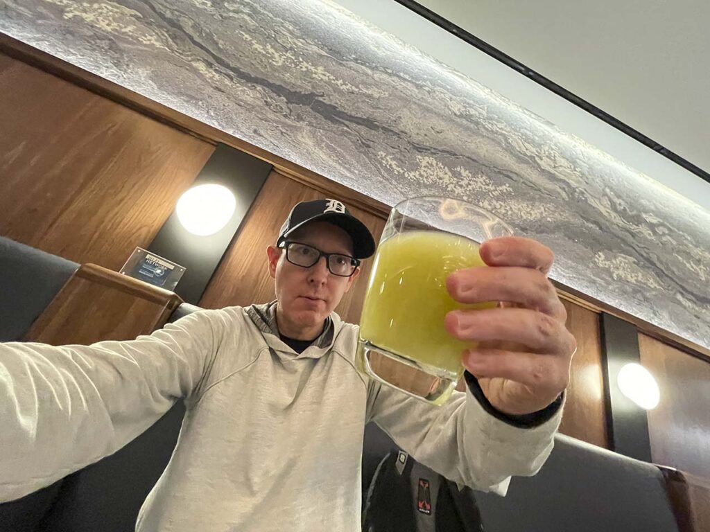 Scott Leazenby drinking Honeydew Lemon Agua Fresca lemonade in the SLC Amex Lounge
